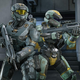 Two Spartans stand next to each other wielding battle rifles in Halo Infinite.